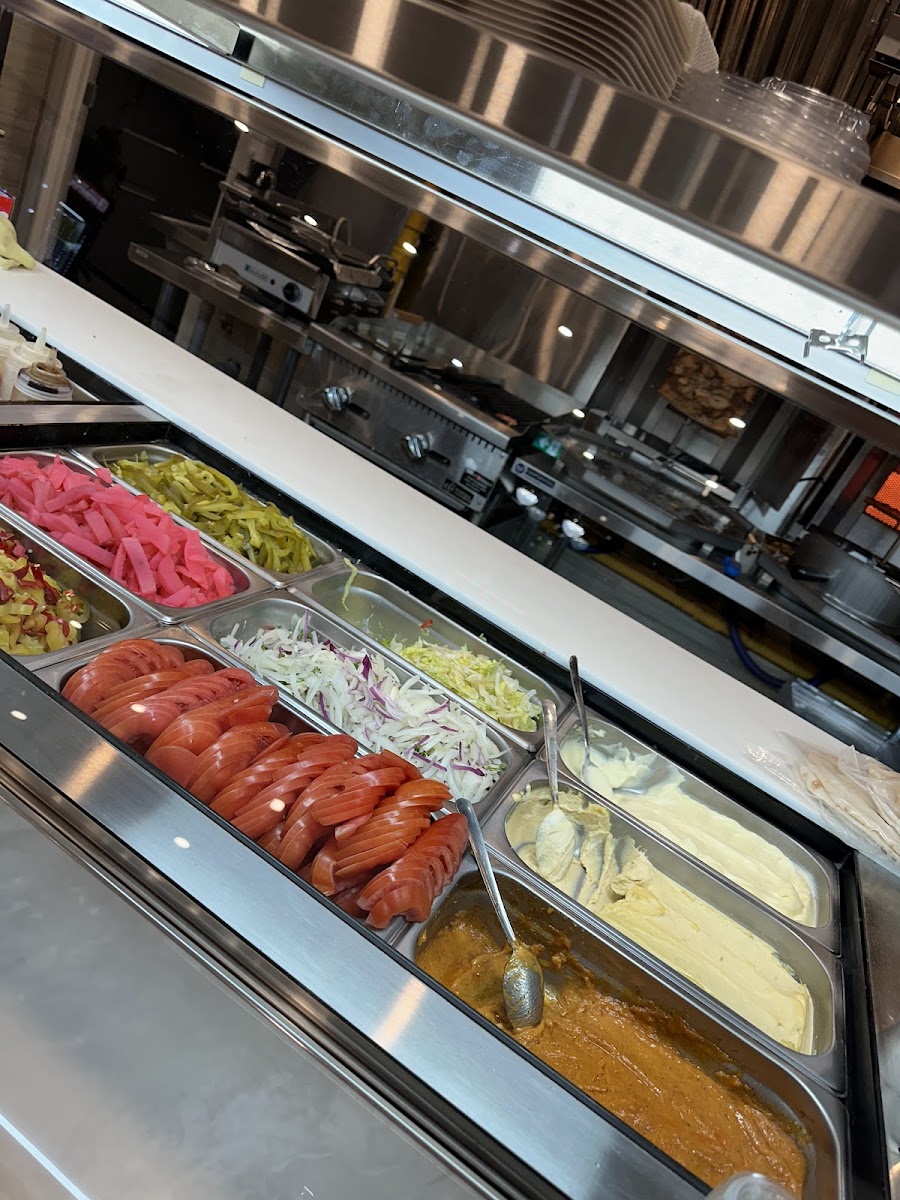 The stainless topping bar with salads, pickled vegetables and sauces