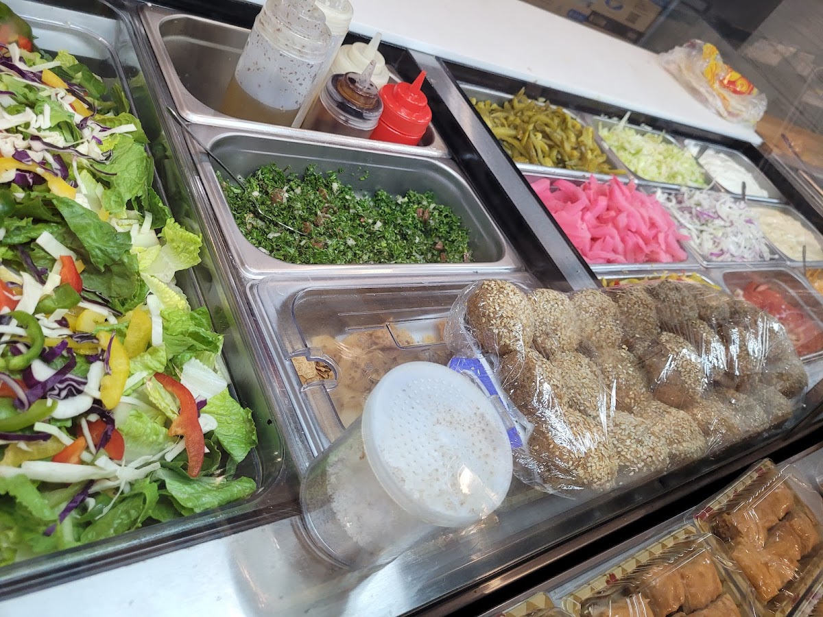The display bar with tabbouleh, salads, pickled turnips and falafel balls